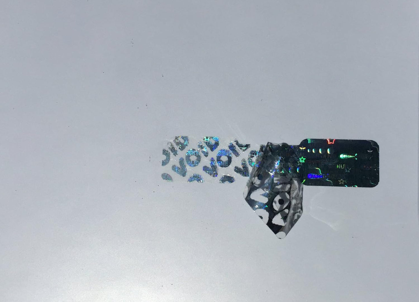 10,000 Silver Dog Bone Hologram Sticker TamperMax Tamper Evident Security Label Holographic Seal Sticker, Size 1.75" x 0.375" (44mm x 9mm).